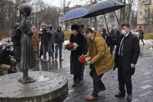 La Secretaria de Relaciones Exteriores británica Liz Truss y el Ministro de Relaciones Exteriores de Ucrania Dmytro Kuleba pusieron flores frente al Monumento Holodomor en el Museo Nacional del Holodomor-Genocidio en Kiev, el 17 de febrero de 2022. - Millones murieron en la hambruna de Holodomor de 1932-33 durante la era soviética. (Foto por ANTONIO BRONIC / PISCINA / AFP)