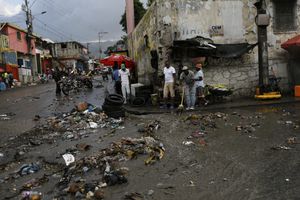 Debris litters a street caused by a flood of water brought on by heavy rains that fell over Port-au-Prince, Haiti, Friday, July 9, 2021, two days after Haitian President Jovenel Moise was assassinated in his home.  (AP Photo/Fernando Llano)