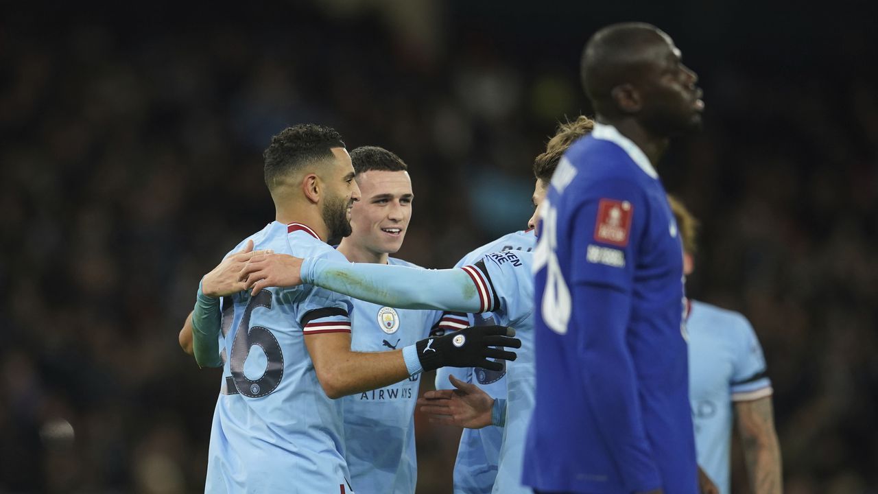 Manchester City's Riyad Mahrez, left, celebrates with teammates after scoring his side's fourth goal during the English FA Cup soccer match between Manchester City and Chelsea at the Etihad Stadium in Manchester, England, Sunday, Jan. 8, 2023. (AP Photo/Dave Thompson)