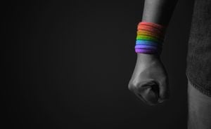 Power, Protest and Expression for LGBTQ, Rights Concept. Closeup of Fist and Rainbow Wrist Strap. Angry, Ready to Punch. Cropped and Selective Focus