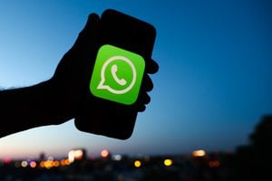 WhatsApp logo displayed on a phone screen and a view of the city in the background are seen in this illustration photo taken in Krakow, Poland on June 6, 2022. (Photo by Jakub Porzycki/NurPhoto via Getty Images)