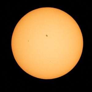 In this handout photo released by NASA, the International Space Station, with a crew of seven aboard, is seen in silhouette as it transits the sun at roughly five miles per second, April 23, 2021, as seen from Nottingham, Maryland. - Aboard are: NASA astronauts Shannon Walker, Mike Hopkins, Victor Glover, Mark Vande Hei; Roscosmos cosmonauts Oleg Novitskiy, Pyotr Dubrov; and Japan Aerospace Exploration Agency (JAXA) astronaut Soichi Noguchi. Joining the crew aboard station tomorrow will be Crew-2 mission crew members: NASA astronauts Shane Kimbrough and Megan McArthur, JAXA astronaut Akihiko Hoshide, and ESA (European Space Agency) astronaut Thomas Pesquet. (Photo by Bill INGALLS / NASA / AFP) / RESTRICTED TO EDITORIAL USE - MANDATORY CREDIT "AFP PHOTO / NASA / Bill INGALLS  " - NO MARKETING - NO ADVERTISING CAMPAIGNS - DISTRIBUTED AS A SERVICE TO CLIENTS