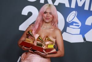SEVILLE, SPAIN - NOVEMBER 16: Karol G poses with the awards for Best Recording of the Year, Best Urban Album of the Year, and Best Album of the Year in the media center for The 24th Annual Latin Grammy Awards  at FIBES Conference and Exhibition Centre on November 16, 2023 in Seville, Spain. (Photo by Patricia J. Garcinuno/WireImage)