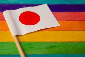 Japan flag on rainbow background symbol of LGBT gay pride month  social movement rainbow flag is a symbol of lesbian, gay, bisexual, transgender, human rights, tolerance and peace.