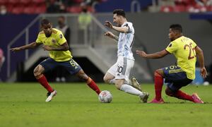Argentina's Lionel Messi, center, and Colombia's Frank Fabra, right, battle for the ball during a Copa America semifinal soccer match at the National stadium in Brasilia, Brazil, Tuesday, July 6, 2021. (AP Photo/Eraldo Peres)