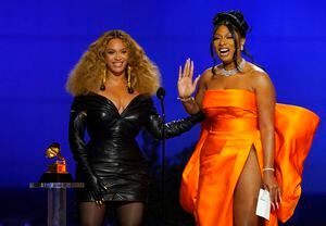 Beyonce, left, and Megan Thee Stallion accept the award for best rap song for "Savage" at the 63rd annual Grammy Awards at the Los Angeles Convention Center on Sunday, March 14, 2021. (AP Photo/Chris Pizzello)