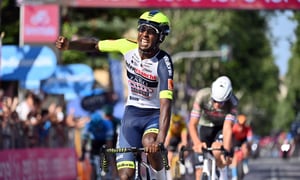 Eritrea's Biniam Girmay celebrates as he crosses the finish line of the 10th stage of the Giro D'Italia cycling race from Pescara to Jesi, Italy, Tuesday, May 17, 2022. (Massimo Paolone/LaPresse via AP)