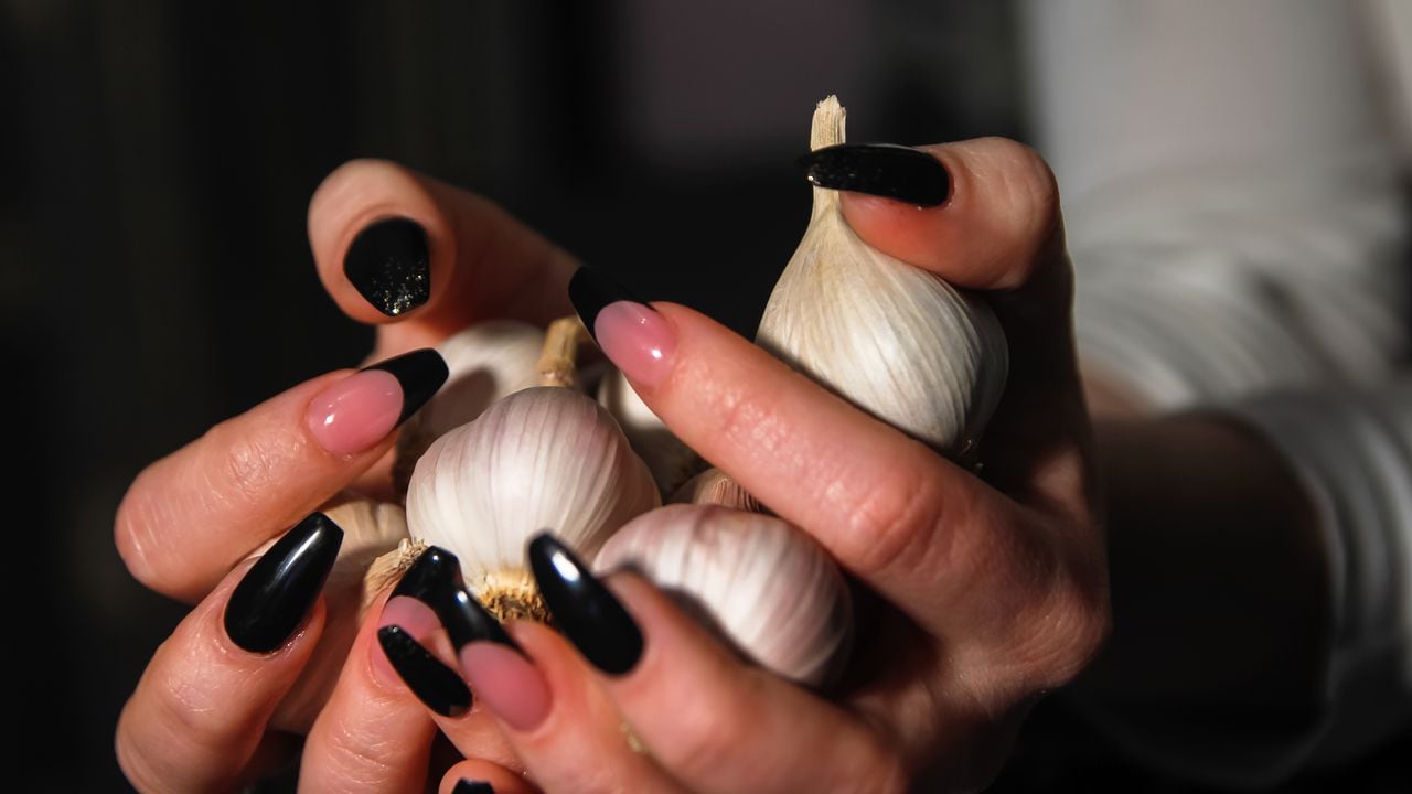 Women's hands holding garlic