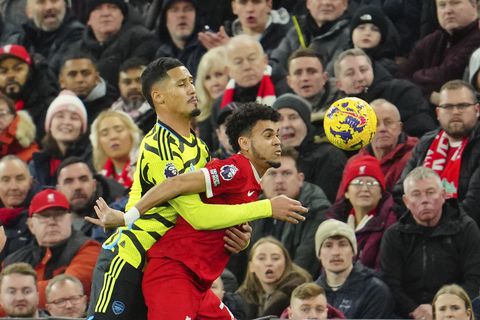Liverpool's Luis Diaz, right, is challenged by Arsenal's William Saliba during the English Premier League soccer match between Liverpool and Arsenal at Anfield stadium in Liverpool, England, Saturday, Dec. 23, 2023. (AP Photo/Jon Super)