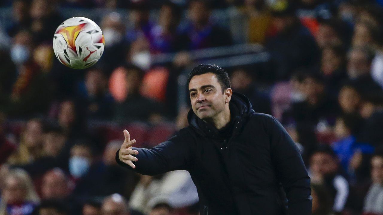 Barcelona's head coach Xavi Hernandez throws a ball during a Spanish La Liga soccer match between FC Barcelona and Cadiz at the Camp Nou stadium in Barcelona, Spain, Monday, April 18, 2022. (AP/Joan Monfort)