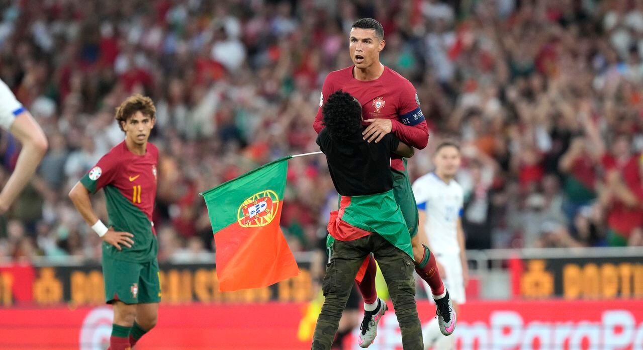 Un individuo que irrumpió en la cancha para abraza al astro portugués Cristiano Ronaldo durante el partido contra
Bosnia y Herzegovina por las eliminatorias de la Eurocopa.