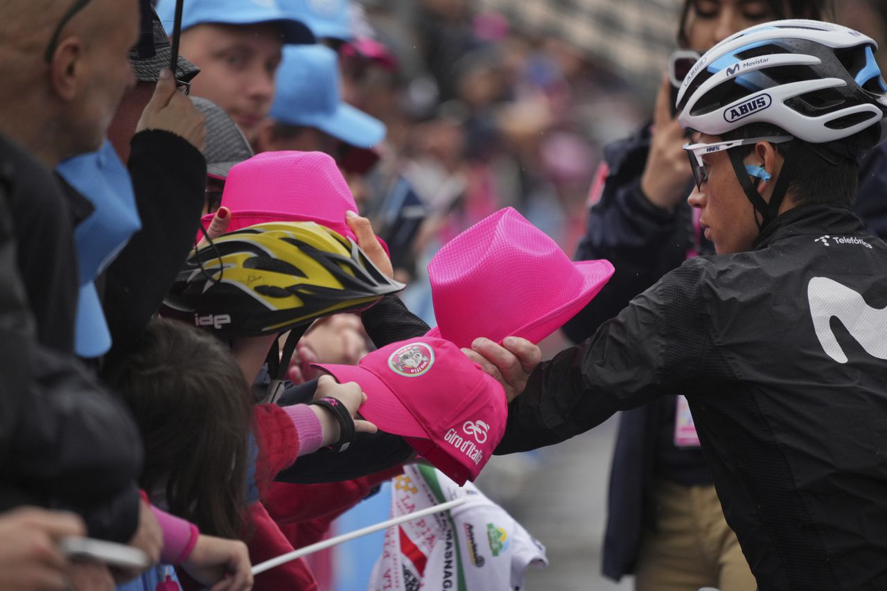 Colombia's Einer Augusto Rubio signs autographs, ahead of the start of the 15th stage of the Giro D'Italia, tour of Italy cycling race from Seregno to Bergamo, Italy, Sunday, May 21, 2023.  (Gian Mattia D'Alberto/LaPresse via AP)