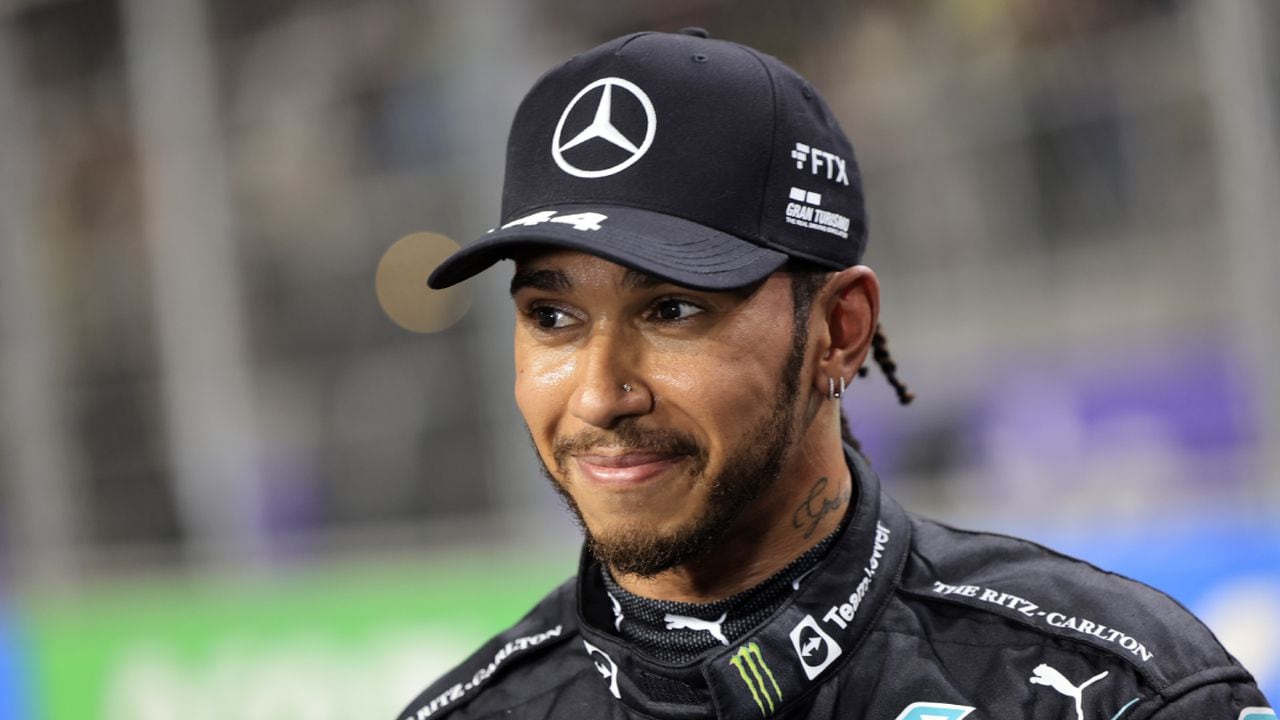 FILE- Mercedes driver Lewis Hamilton, of Britain smiles, after winning the pole position during qualifying for the Formula One Saudi Arabian Grand Prix auto race on Dec. 4, 2021, in Jiddah, Saudi Arabia. Hamilton returned to social media Saturday, Feb. 5, 2022, following a lengthy silence that dates to last season's controversial Formula 1 finale. (AP/Giuseppe Cacace/Pool)