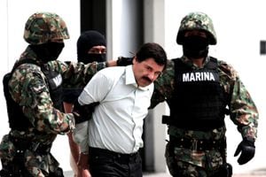 Mexican Navy soldiers escort Joaquin Guzman Loera (front), alias "El Chapo Guzman", leader of the Sinaloa Cartel, during his show up in front of the press, at the Mexican Navy hangar in Mexico City, capital of Mexico, on Feb. 22, 2014. Mexican President Enrique Pena Nieto on Saturday confirmed the capture of the world's most wanted drug lord, Joaquin Guzman Loera, known as El Chapo, in the Pacific resort of Mazatlan. (Photo by Jair Cabrera Torres/NurPhoto) (Photo by NurPhoto/Corbis via Getty Images)