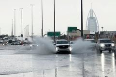 Una camioneta arroja agua a su paso por una carretera anegada, con el edificio Burj Al Arab, de fondo, en Dubái, Emiratos Árabes Unidos, el 16 de abril de 2024. (AP Foto/Jon Gambrell)