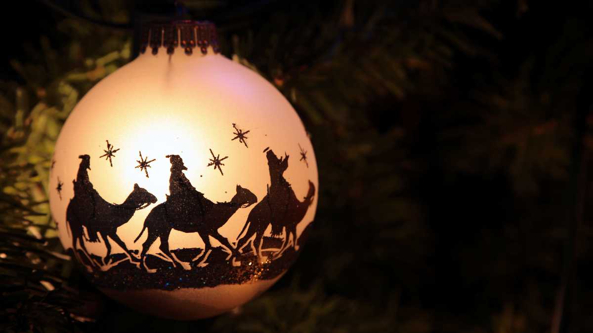 Christmas ornament with silhouettes of the 3 wise men on their camels. Room for copy space. Horizontal image would be good for Christian or religious Christmas use.
