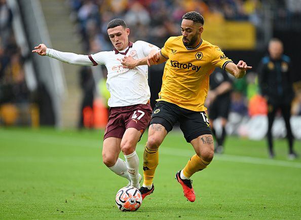 WOLVERHAMPTON, ENGLAND - SEPTEMBER 30: Phil Foden of Manchester City battles for possession with Matheus Cunha of Wolverhampton Wanderers during the Premier League match between Wolverhampton Wanderers and Manchester City at Molineux on September 30, 2023 in Wolverhampton, England. (Photo by Michael Regan/Getty Images)