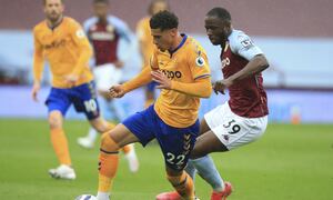 Everton's Ben Godfrey, left, and Aston Villa's Marvelous Nakamba challenge for the ball during the English Premier League soccer match between Aston Villa and Everton at Villa Park in Birmingham, England, Thursday, May 13, 2021. (AP Photo/Lindsey Parnaby, Pool)