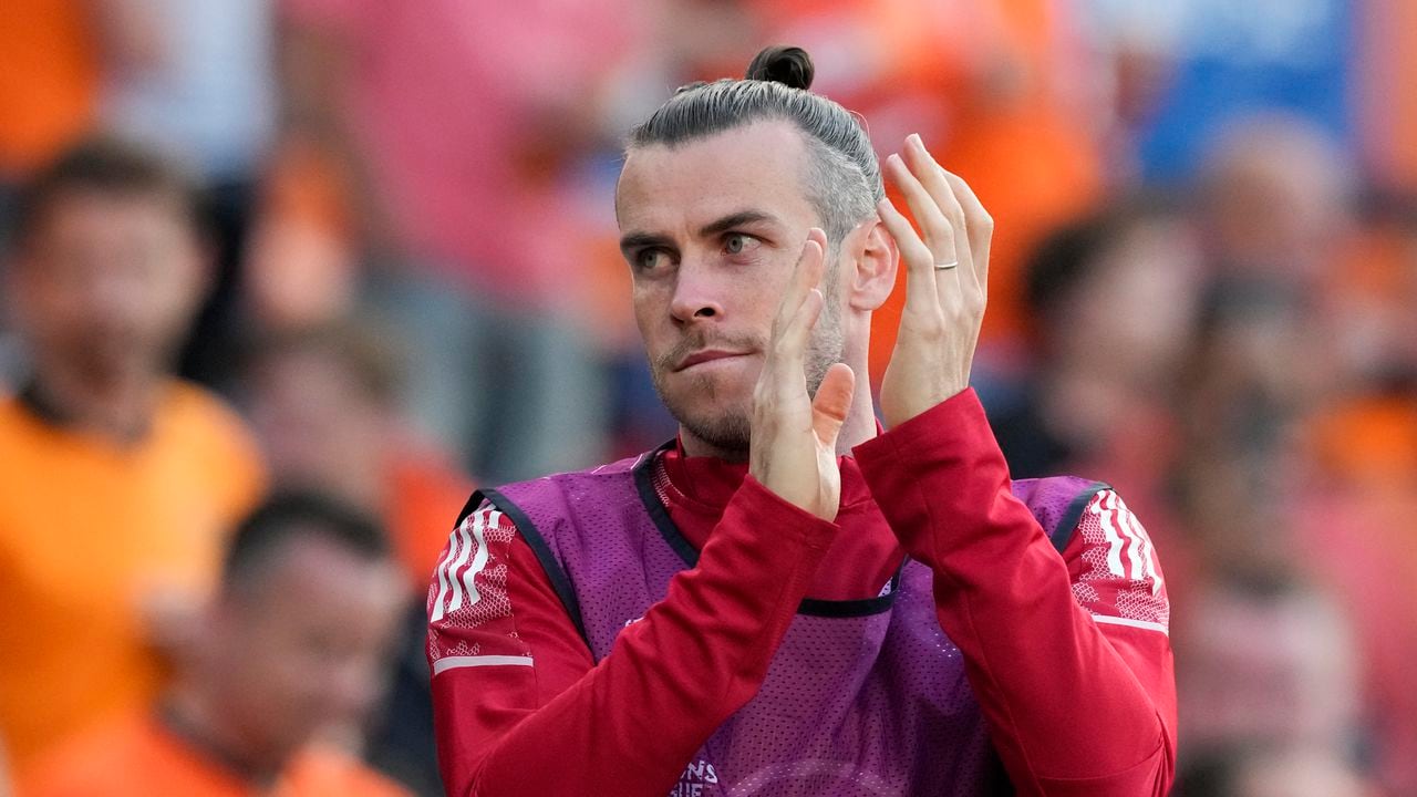 Wales' Gareth Bale warms up for a possible substitution during the UEFA Nations League soccer match between the Netherlands and Wales at De Kuip stadium in Rotterdam, Netherlands, Tuesday, June 14, 2022. (AP Photo/Peter Dejong)