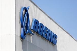(FILES) In this file photo taken on April 20, 2020 the Boeing logo is pictured at its Renton Factory in Renton, Washington. - US plane maker Boeing reached a pair of major agreements with Qatar Airways, including the sale of 34 777X freighters worth an estimated $20 billion, the White House announced on January 31,2022. Besides the 34 planes, Qatar Airways also has purchase rights for another 16 777X cargo planes. (Photo by Jason Redmond / AFP)