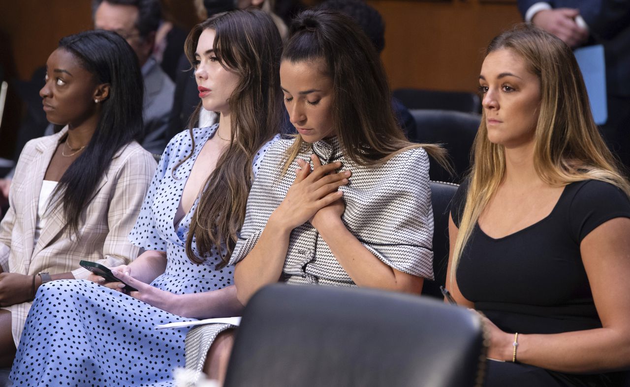 FILE - United States gymnasts from left, Simone Biles, McKayla Maroney, Aly Raisman and Maggie Nichols, arrive to testify during a Senate Judiciary hearing about the Inspector General's report on the FBI's handling of the Larry Nassar investigation, Wednesday, Sept. 15, 2021, on Capitol Hill in Washington.  Long sought sexual assault measures in Michigan first introduced in the wake of the Larry Nassar scandal will soon be implemented after Michigan Gov. Gretchen Whitmer signed legislation Thursday, June 29, 2023. The package will create stricter punishments for sexual assault under the guise of medical treatment and protect students who report it. It will also require the creation and distribution of comprehensive training materials for people required to report suspected child abuse and neglect. (Saul Loeb/Pool Photo via AP, File)