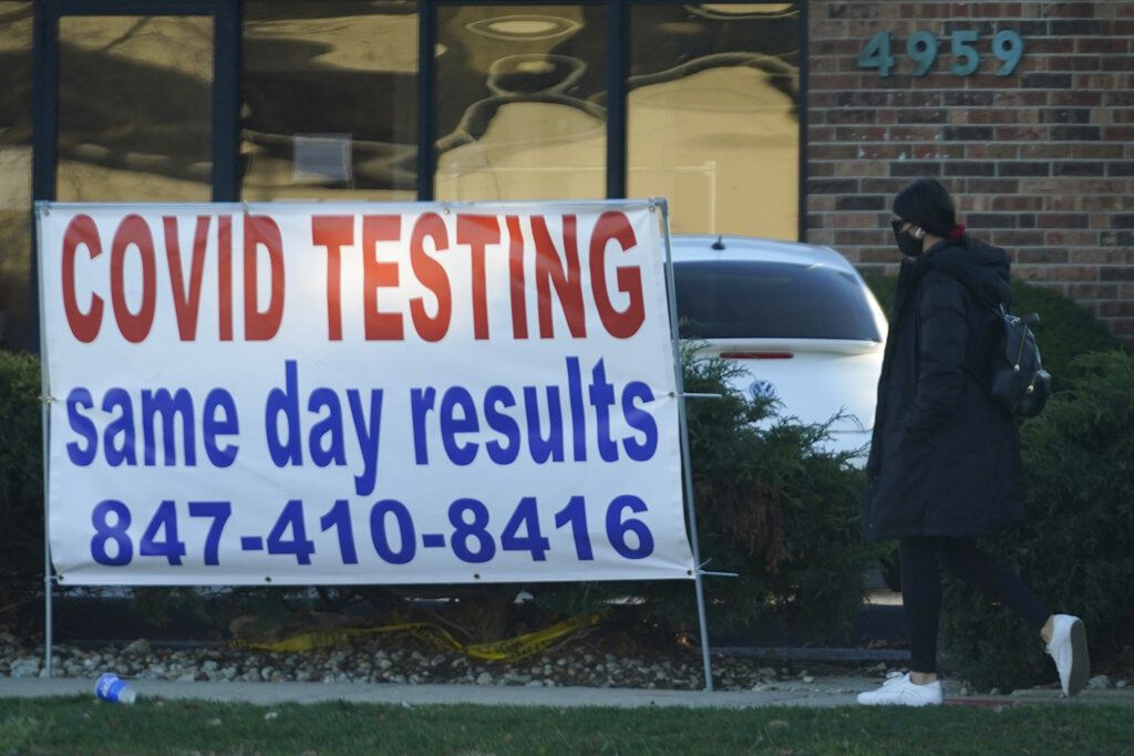 FILE - In this Nov. 28, 2020, file photo, a COVID-19 testing sign is displayed outside of the Elterman Center for Women's and Men's Health in Skokie, Ill. Deaths related to the coronavirus pandemic in Illinois have topped 200 for the first time. The record 238 fatalities reported Wednesday, Dec. 2, 2020, was nearly one-quarter higher than the previous high, set during the spring onslaught of the illness. (AP Photo/Nam Y. Huh File)