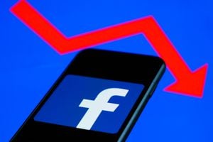 Facebook logo displayed on a phone screen and an illustrative graph displayed on a screen are seen in this illustration photo taken in Krakow, Poland on February 6, 2022. (Photo illustration by Jakub Porzycki/NurPhoto via Getty Images)
