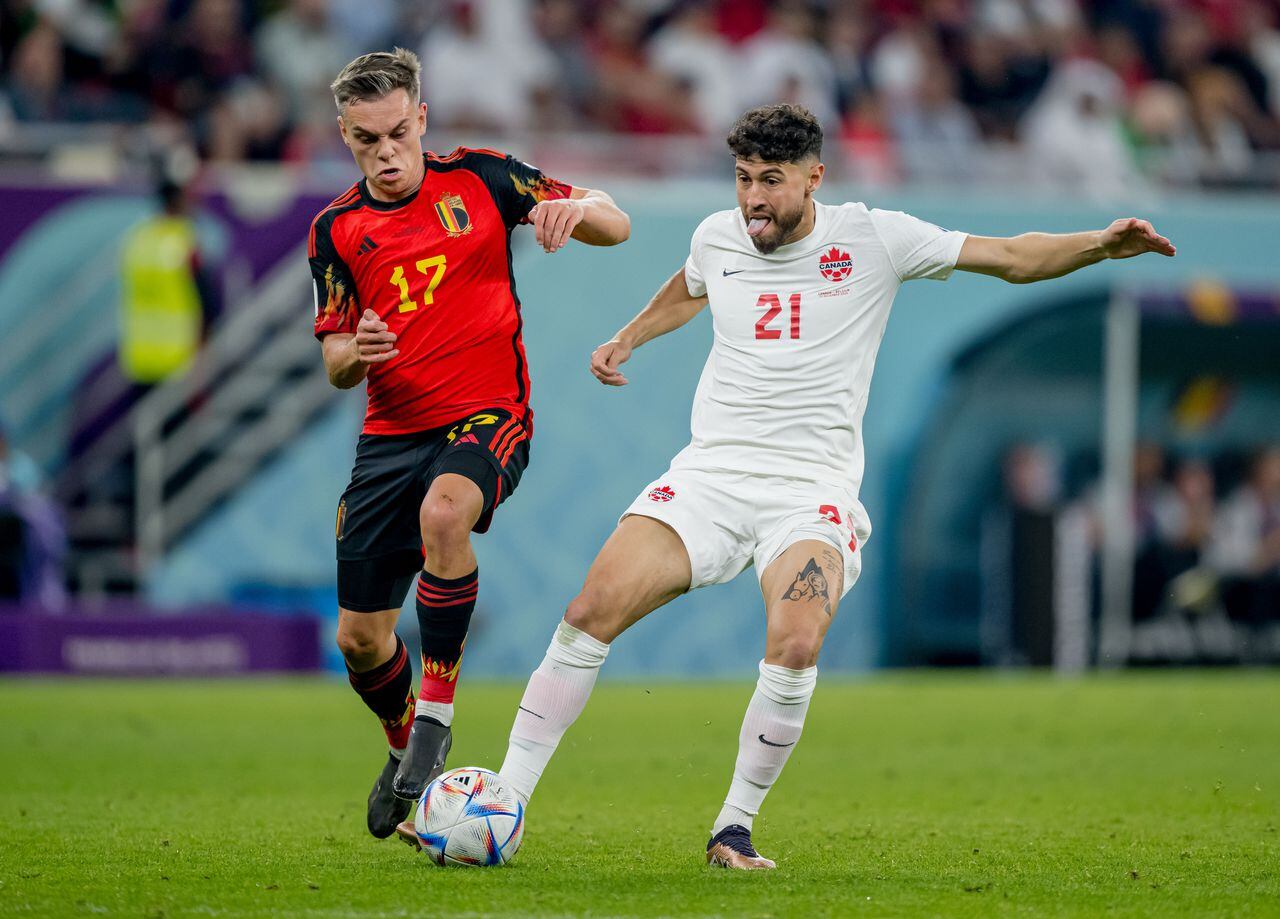 DOHA, QATAR - NOVEMBER 23: Leandro Trossard (L) of Belgium in action with Jonathan Osorio of Canada during the FIFA World Cup Qatar 2022 Group F match between Belgium and Canada at Ahmad Bin Ali Stadium on November 23, 2022 in Doha, Qatar.