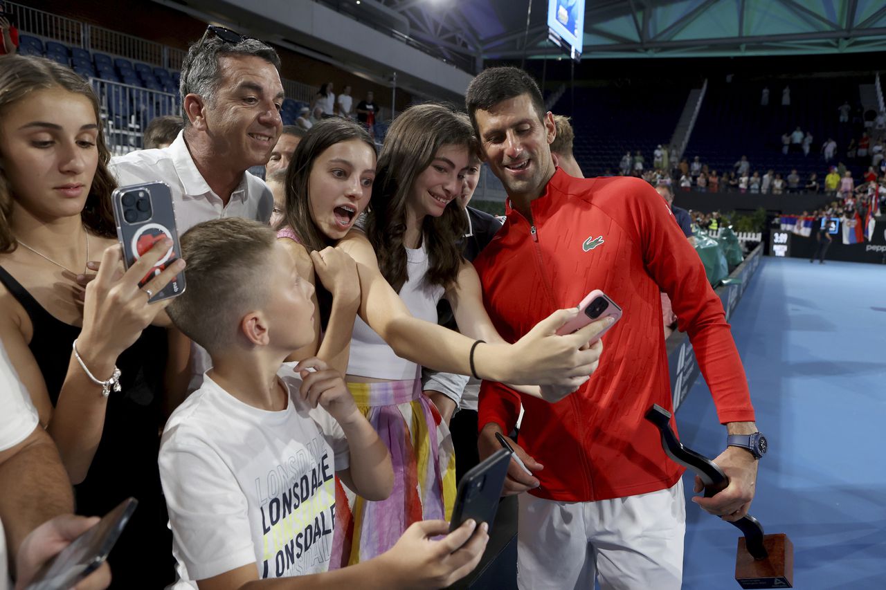 Serbia's Novak Djokovic poses for a selfie after winning the final of the Adelaide International tennis tournament against USA's Sebastian Korda in Adelaide, Australia, Sunday, Jan. 8, 2023. (AP Photo/Kelly Barnes)