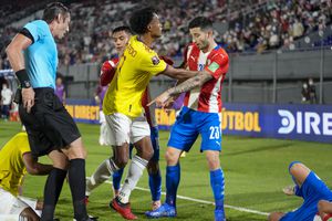 Colombia's Juan Cuadrado and Paraguay's Mathias Villasanti (23) argue during a qualifying soccer match for the FIFA World Cup Qatar 2022 in Asuncion, Paraguay, Sunday, Sept. 5, 2021. (AP Photo/Jorge Saenz)