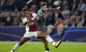 Ajax's Jurrien Timber, left, challenges Napoli's Khvicha Kvaratskhelia during the Champions League group A soccer match between Ajax and Napoli at the Johan Cruyff ArenA in Amsterdam, Netherlands, Tuesday, Oct. 4, 2022. (AP Photo/Peter Dejong)