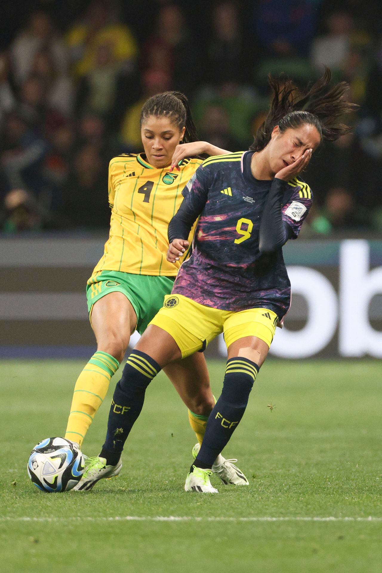 Colombia's Mayra Ramirez, right, touches her eye as in action with Jamaica's Chantelle Swaby during the Women's World Cup round of 16 soccer match between Jamaica and Colombia in Melbourne, Australia, Tuesday, Aug. 8, 2023. (AP Photo/Hamish Blair)