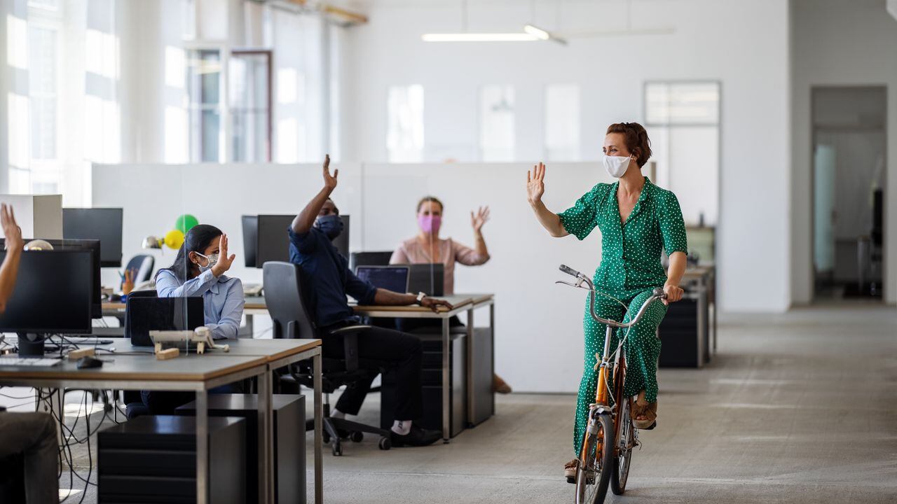 Foto de referencia de una mujer montando bicicleta en una oficina