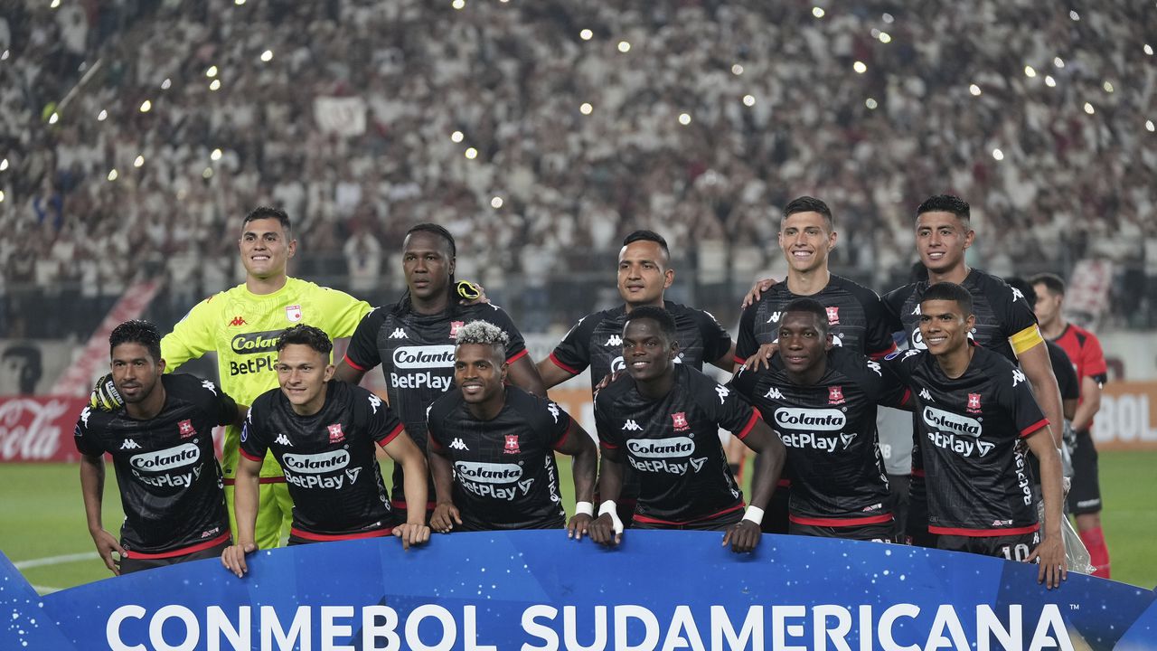 The starting players of Colombia's Independiente Santa Fe pose for a team photo prior to a Copa Sudamericana group G soccer match against Peru's Universitario at Monumental stadium in Lima, Peru, Thursday, May 4, 2023. (AP Photo/Martin Mejia)