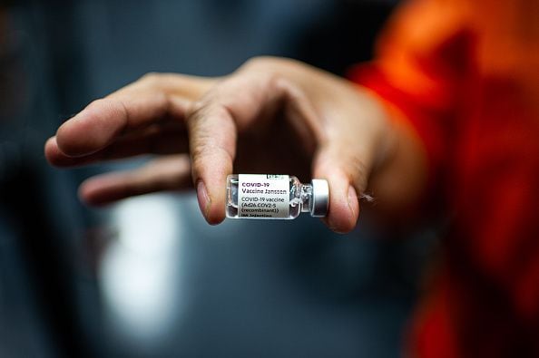 A nurse holds a vial of the Janssen COVID-19 vaccine against the Coronavirus disease during the mass delivery of Temporary Residence Permits for Venezuelan migrants on January 27, 2022. Colombia Migration is organizing mass events to grant more than 70.000 temporary permissions ID's to Venezuelan migrants in the span of 7 days. (Photo by Sebastian Barros/NurPhoto via Getty Images)