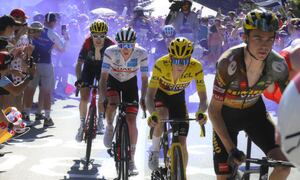 Sepp Kuss of the U.S., Denmark's Jonas Vingegaard, wearing the overall leader's yellow jersey, Slovenia's Tadej Pogacar, wearing the best young rider's white jersey, and Britain's Geraint Thomas, from right, climb Alpe d'Huez during the twelfth stage of the Tour de France cycling race over 165.5 kilometers (102.8 miles) with start in Briancon and finish in Alpe d'Huez, France, Thursday, July 14, 2022. (Bernard Papon/Pool Photo via AP)