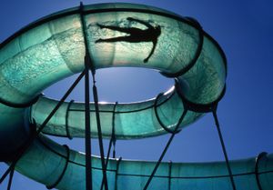 A person takes a ride on a curving water slide in Logan, Utah, USA.