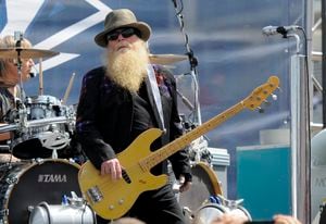 FILE - Dusty Hill, of ZZ Top, performs before the start of the NASCAR Sprint Cup series auto race in Concord, N.C., May 24, 2015. ZZ Top has announced that Hill, one of the Texas blues trio's bearded figures and bassist, has died at his Houston home. He was 72. In a Facebook post, bandmates Billy Gibbons and Frank Beard revealed Wednesday, July 29, 2021, that Hill had died in his sleep. (AP Photo/Mike McCarn, File)