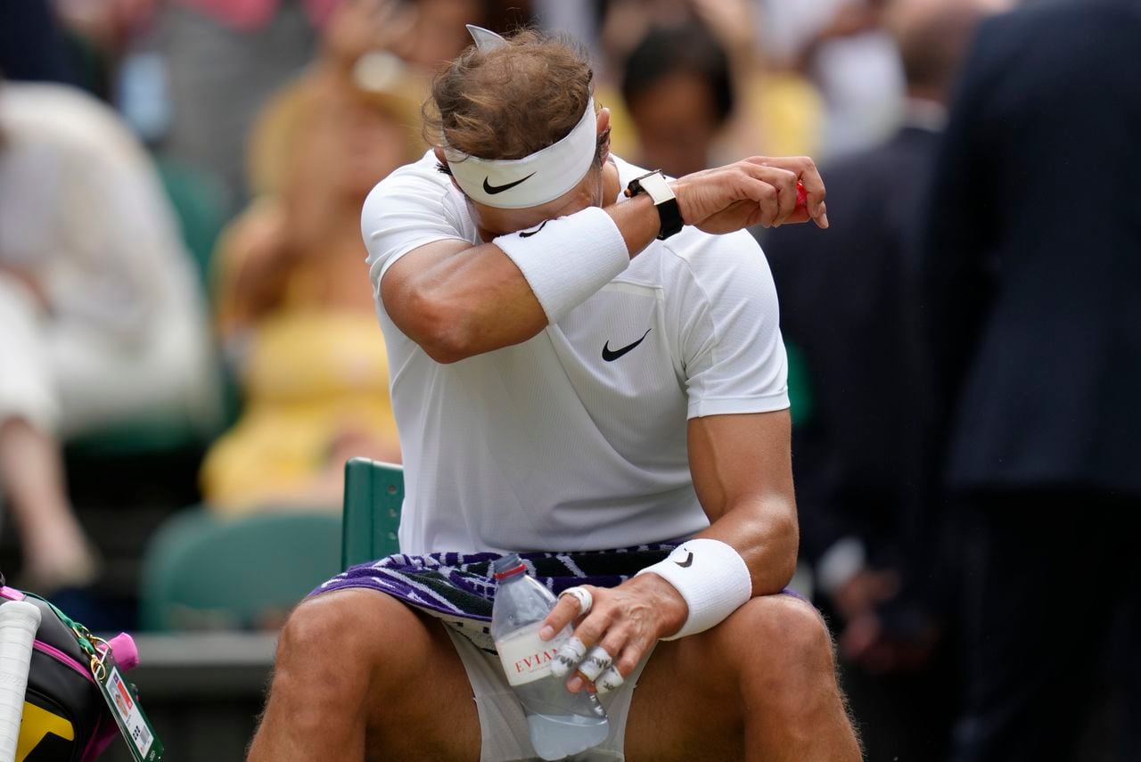 Spain's Rafael Nadal reacts during a change of ends break as he plays Taylor Fritz of the US in a men's singles quarterfinal match on day ten of the Wimbledon tennis championships in London, Wednesday, July 6, 2022. (AP Photo/Kirsty Wigglesworth)