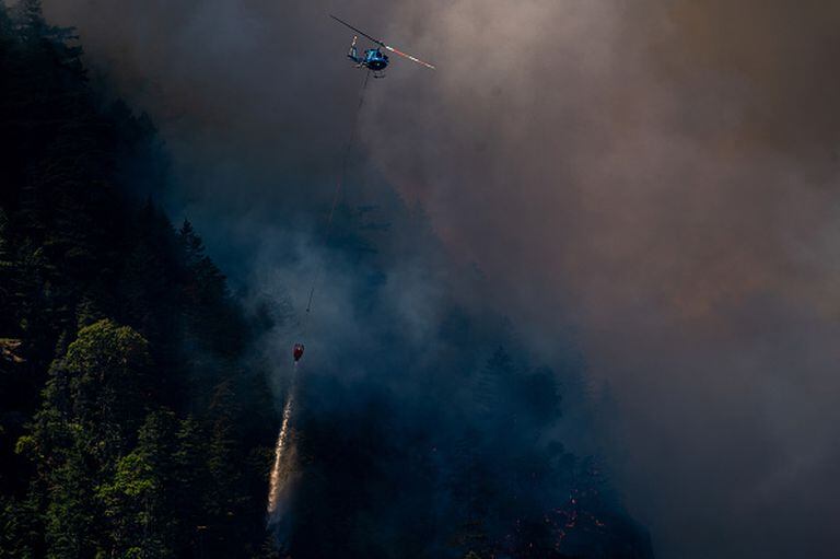 Un helicóptero lanza bombas de agua sobre el incendio forestal de Cameron Bluffs cerca de Port Alberni, Columbia Británica, Canadá, el martes 6 de junio de 2023. Canadá está en camino de ver su peor temporada de incendios forestales en la historia registrada si la tasa de tierra quemada continúa en el mismo ritmo Fotógrafo: James MacDonald/Bloomberg vía Getty Images