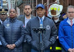 New York Police commissioner Keechant Sewell stands next to New York Mayor Eric Adams as he speaks on the scene of a parking garage that collapsed in lower Manhattan, New York City, on April 18, 2023. (Photo by Peter GERBER / AFP)