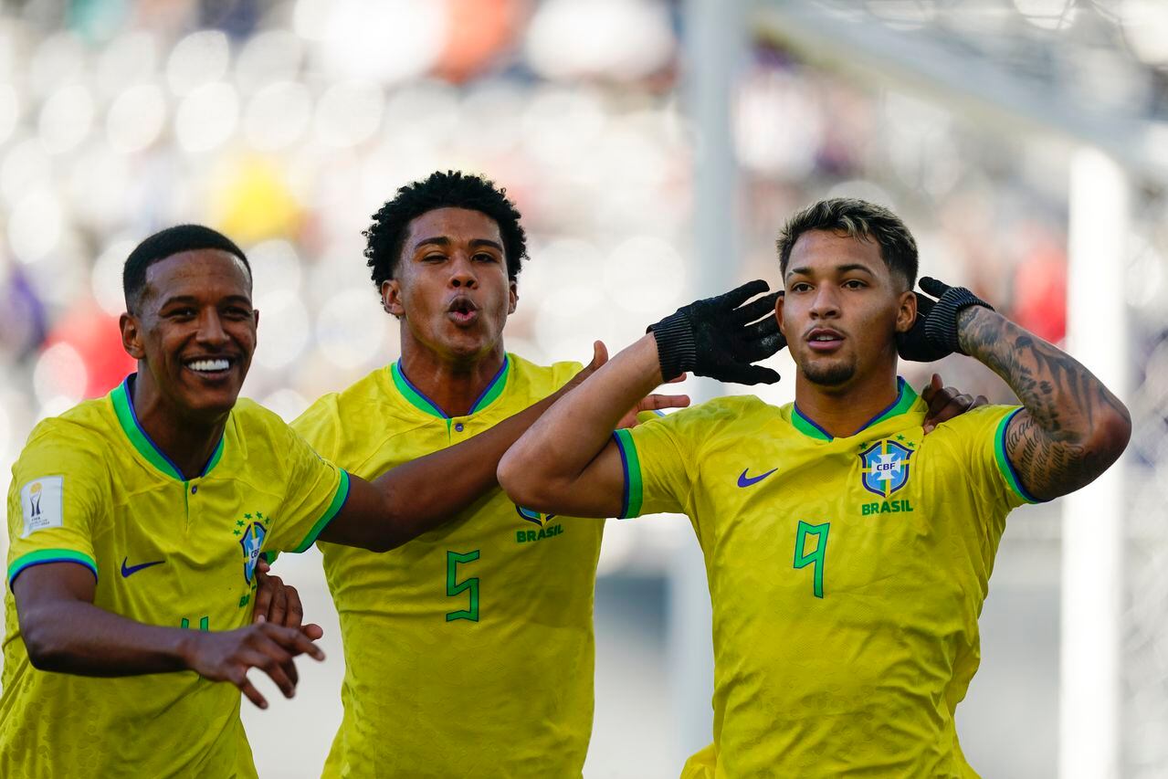 Brazil's Marcos Leonardo, right, celebrates with teammates Andrey Santos, center, and Robert Renan after scoring his side's opening goal from the penalty spot during a FIFA U-20 World Cup round of 16 soccer match against Tunisia at La Plata Stadium in La Plata, Argentina, Wednesday, May 31, 2023. (AP Photo/Ivan Fernandez)