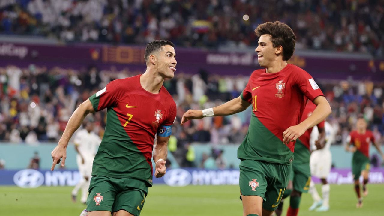 DOHA, QATAR - NOVEMBER 24: Cristiano Ronaldo of Portugal celebrates with Joao Felix after scoring their team's first goal via a penalty during the FIFA World Cup Qatar 2022 Group H match between Portugal and Ghana at Stadium 974 on November 24, 2022 in Doha, Qatar. (Photo by Clive Brunskill/Getty Images)