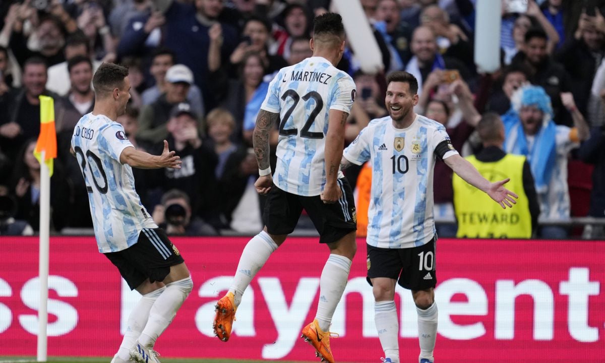 Argentina's Lautaro Martinez, center, celebrates with his teammates Lionel Messi, right, and Giovani Lo Celso after scoring his side's opening goal during the Finalissima soccer match between Italy and Argentina at Wembley Stadium in London , Wednesday, June 1, 2022. (AP/Matt Dunham)