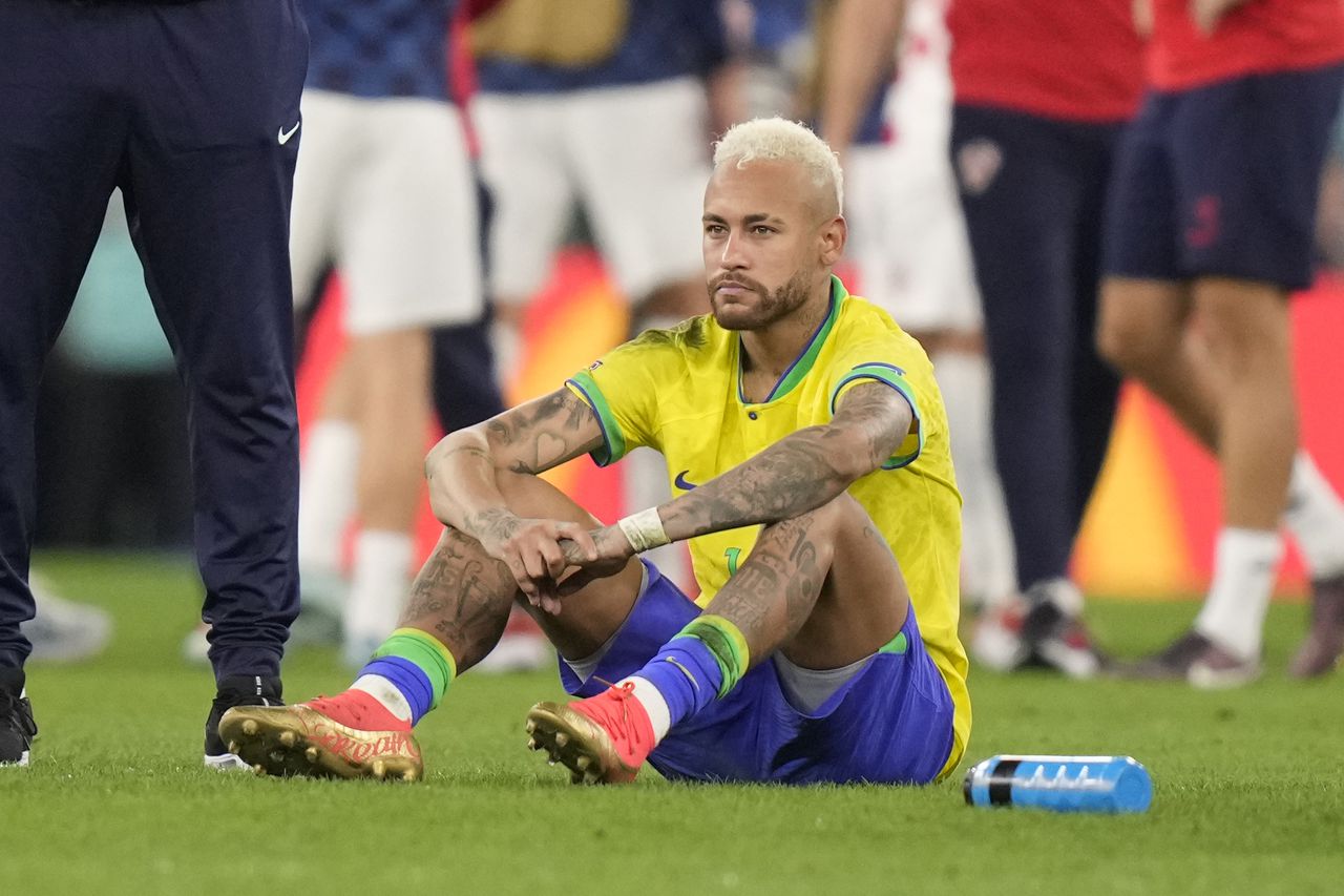 Brazil's Neymar sits on the pitch at the end of the World Cup quarterfinal soccer match between Croatia and Brazil, at the Education City Stadium in Al Rayyan, Qatar, Friday, Dec. 9, 2022. (AP Photo/Darko Bandic)