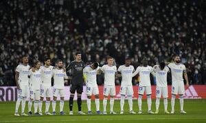 Real Madrid's team players stand on the pitch prior the Spanish La Liga soccer match between Real Madrid and Atletico Madrid at Santiago Bernabeu stadium in Madrid, Spain, Sunday, Dec. 12, 2021. (AP Photo/Bernat Armangue)