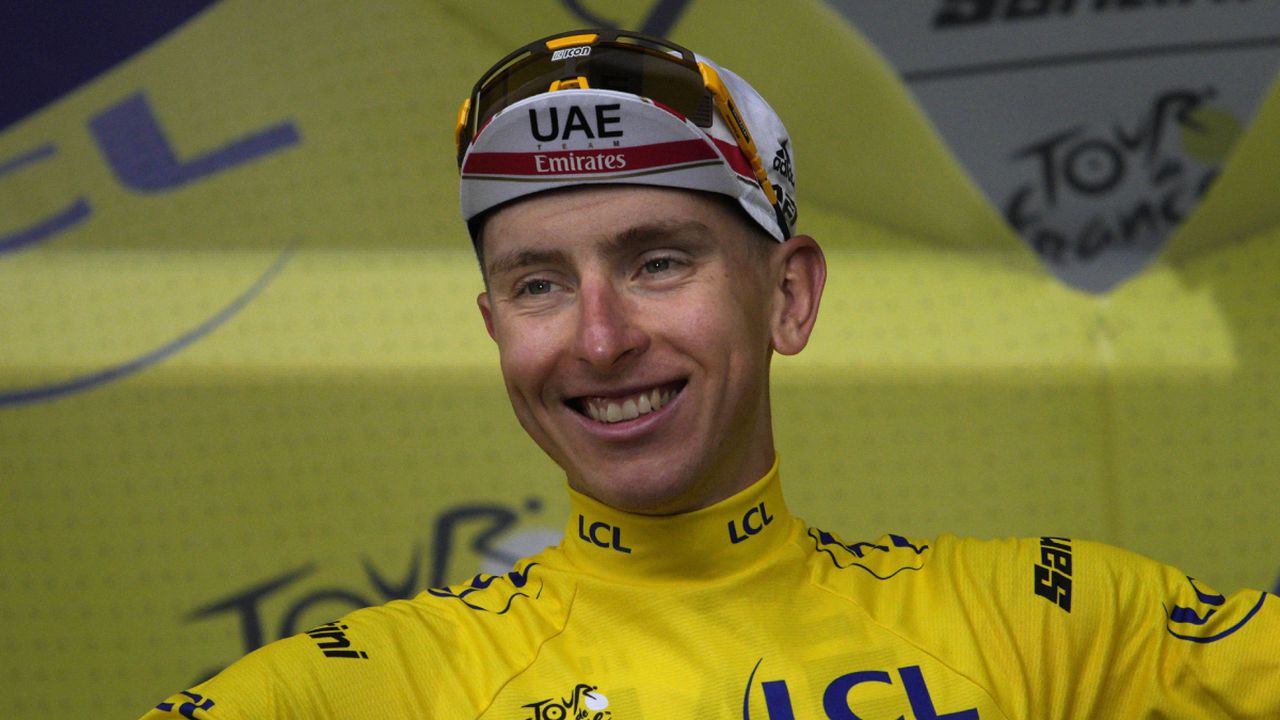 Slovenia's Tadej Pogacar, wearing the overall leader's yellow jersey, celebrates on the podium after winning the sixth stage of the Tour de France cycling race over 220 kilometers (136.7 miles) with start in Binche and finish in Longwy, France, Thursday, July 7, 2022. (AP/Daniel Cole)