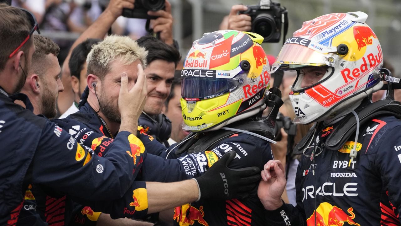 Second placed Red Bull driver Max Verstappen, right, of the Netherlands and first placed Red Bull driver Sergio Perez of Mexico celebrate with their team after the Formula One Grand Prix at the Baku circuit, in Baku, Azerbaijan, Sunday, April 30, 2023. (AP/Darko Bandic)