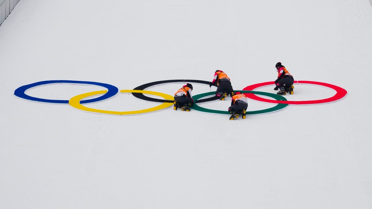 Crews place the Olympic Rings on the large hill before the start of a trial round in the ski jump portion of the individual Gundersen normal hill event at the 2022 Winter Olympics, Wednesday, Feb. 9, 2022, in Zhangjiakou, China. (AP Photo/Andrew Medichini)
