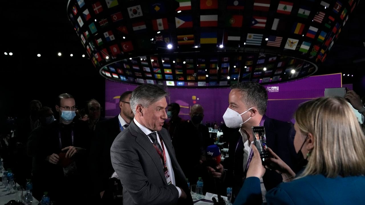 Russia delegate Alexey Sorokin, left, speaks to journalists at the end of the FIFA congress at the Doha Exhibition and Convention Center in Doha, Qatar, Thursday, March 31, 2022. (AP Photo/Hassan Ammar)